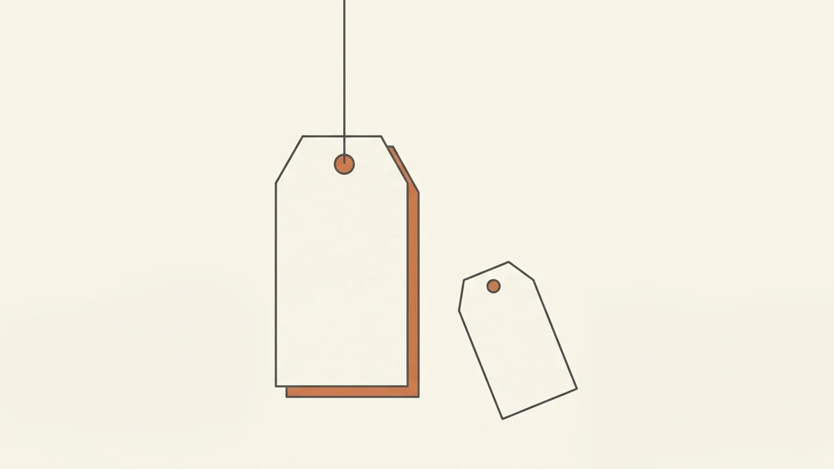 A minimal charcoal line illustration of two blank price tags on a warm cream background, one hanging from a thin string with a terracotta edge and one lying flat beside it